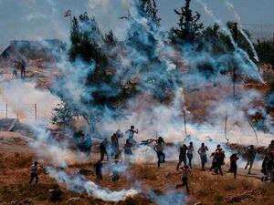 "Gado, 32, a cameraman for the Palestinian News Network, took off the mask he was wearing to protect himself from the tear gas and gave it to the woman." (Facebook)
