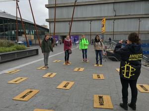 Students lay down "welcome" door mats for Syrian refugees in Netherlands as part of the Utrecht Welcomes Refugees project for Amnesty International. 