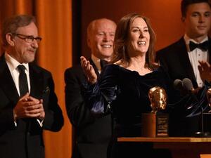 Kathleen Kennedy and Frank Marshall accept the Irving G. Thalberg Memorial Award from Steven Spielberg onstage during the Academy of Motion Picture Arts and Sciences’ 10th annual Governors Awards. (Source: AFP)