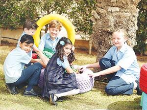 Students at the British International School Riyadh using tires for planting. (AN photo by Bashir Saleh)