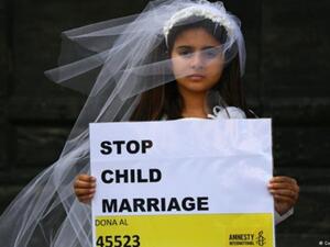 A young actress plays the role of a child bride during a protest organised by Amnesty (AFP/File Photo)	
