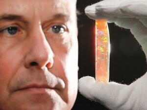 South Australian Museum Director Brian Oldman with the Virgin Rainbow opal — one of the highlights of the exhibition. (Peninsula)