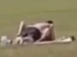 The couple's steamy session was interrupted as they enjoyed an outrageous display in front of children playing sports in a city centre park (Facebook)