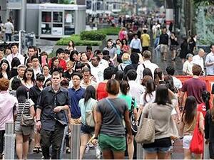 People walking along Orchard Road in Singapore (AFP/File Photo)