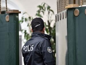 A Turkish police officer opens the door of Saudi Consul's residence on October 17, 2018 in Istanbul. (AFP Photo)