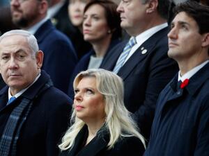 Israeli Prime Minister Benjamin Netanyahu (L) and his wife Sara (C) (AFP)