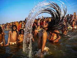 Indian sadhus (Hindu holy men) take a dip into the water of the holy Sangam -- the confluence of the Ganges, Yamuna and mythical Saraswati rivers -- during the auspicious bathing day of Makar Sankranti at the Kumbh Mela in Allahabad (AFP)