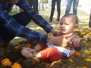 Crying children are placed in cow dung (Twitter)