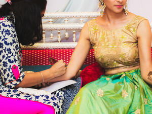 Indian Henna artist making a beautiful mehndi design on the hand (Shutterstock)