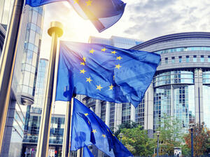 EU flags waving in front of European Parliament building (Shutterstock)