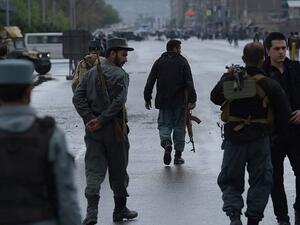 Afghan security forces at the site of a car bombing earlier on April 19. (AFP/Shah Marai) Afghan security forces at the site of a car bombing earlier on April 19. (AFP/Shah Marai)