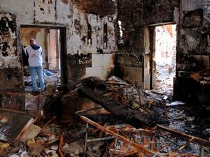 Medecins Sans Frontieres staff walk in the damaged MSF hospital in northern Kunduz, on November 10, 2015. (AFP/Najim Rahim)