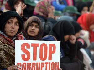 Pakistani supporters of Canadian-Pakistani cleric Tahir-ul Qadri hold placards during a protest march in Islamabad on Tuesday. Police fired tear gas on protesters in Islamabad as clashes erupted. (AFP PHOTO/ Farooq NAEEM)