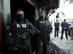 Tunisian special forces stand guard outside a mausoleum ravaged by fire in what is thought to have been an arson attack on Sunday in Sidi Bou Said. (AFP PHOTO /FETHI BELAID)