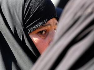 A woman waits for the release of a relative outside the Rusafa prison on Monday. (AFP PHOTO/SABAH ARAR)