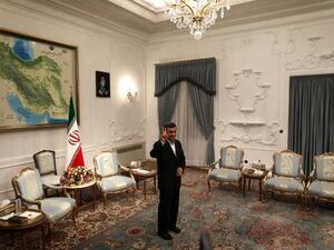 Iranian President Mahmoud Ahmadinejad flashes a victory sign ahead of his meeting with Syrian Prime Minister Wael al-Halaqi in Tehran. (AFP PHOTO/BEHROUZ MEHRI)
