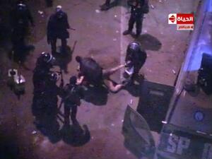 An image grab taken from Al-Hayat TV purportedly shows Egyptian riot police dragging and beating an unidentified semi-naked man during clashes with anti-president protestors outside the Presidential Palace. (AFP PHOTO/Al-Hayat TV)