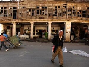 Iraqis walk in al-Rasheed street, the oldest street in the Iraqi capital Baghdad. (AFP PHOTO/PATRICK BAZ)