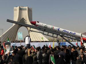 The capsule that was sent into space containing a live monkey in January is displayed during a rally in Tehran's Azadi Square (Freedom Square) to mark the 34th anniversary of the Islamic revolution. (AFP PHOTO / ATTA KENARE)