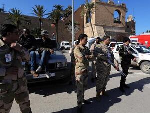 Members of the Libyan security forces and armed civilians monitor a check point at Martyrs square in Tripoli. (AFP PHOTO/MAHMUD TURKIA)