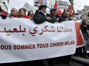 People hold a banner reading "We are all Chokri Belaid" during a protest to pay tribute to murdered opposition figure in Paris. (AFP PHOTO MEHDI FEDOUACH)