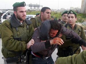 Israeli border policemen arrest a Palestinian man at the entrance of the village of Zayem, as he was on his way to join an "outpost" named Bab al-Shams. (TOPSHOTS/AFP PHOTO/MUSA AL SHAER)