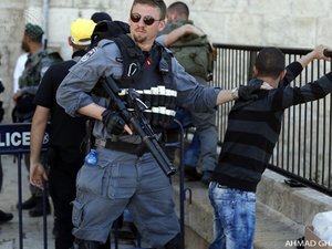 An Israeli Soldier with a Plestinian Child. (AFP File Photo)