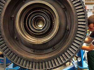 A trainee dismantles a gas turbine for maintenance work in a factory in Ludwigsfelde, Germany. President Trump has called the German apprenticeship system a model program.  (© AP Images)