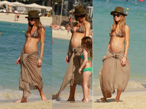 British model Abbey Clancy walks with her daughter down a beach in Dubai. (Image: Daily Mail)