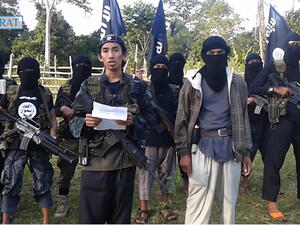 Abu Sayyaf militants marching in Philippines. (Screenshot)