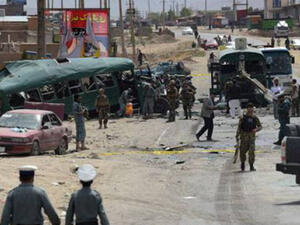 Afghan security personnel gather near the wreckage of buses which were carrying police cadets, at the site of a bomb attack on the outskirts of Kabul on June 30, 2016. (AFP)