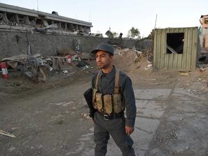 An Afghan policeman stands near the scene of a truck bomb attack in Kabul on May 31, 2017. (AFP/Wakil Kohsar)