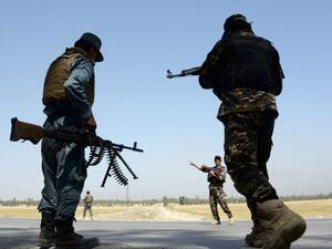 Afghan security personnel stand guard at a checkpoint on the outskirts of Jalalabad on April 28, 2017. (AFP/Noorullah Shirzada)