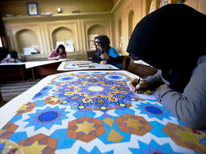 Young women work on geometric designs and calligraphy art at Turquoise Mountain Institute. (Courtesy Turquoise Mountain)