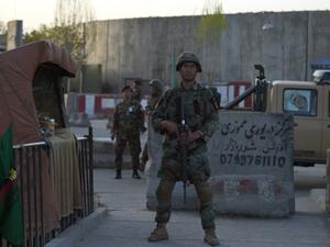 Afghan security personnel stand guard at the site of a suicide attack near the Ministry of Defense in Kabul on April 12, 2017. (AFP/Wakil Kohsar)