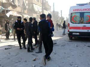 Aleppo residents walk toward an ambulance after one of many Russian airstrikes on the town. (AFP/File)