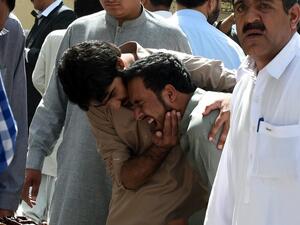 Pakistani journalists grieve over the body of a news cameraman after an explosion at a government hospital in Quetta on Monday. (AFP/File) 