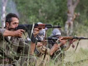 PKK fighters take position with their rife during a traning session. (AFP/File) 