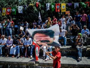 A boy waves a flag with a picture of the PKK's jailed leader Abdullah Ocalan at a rally in the Gazi district of Istanbul on July 23, 2016 (AFP/Ozan Kose)