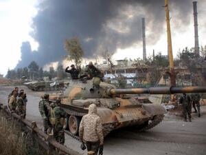 Syrian government forces patrol near Aleppo's thermal power plant after they took control of the area from Islamic State (IS) group fighters (AFP/George Ourfalian)
