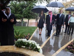 Their Majesties King Abdullah and Queen Rania join family members of the Amman bombing victims at a ceremony marking the tenth anniversary of the attacks last year. (AFP/File) 