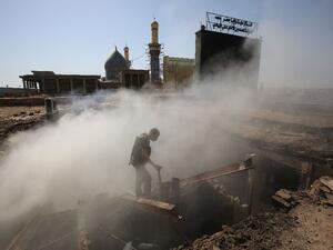 A policeman inspects the scene of a mortar and bombing attack on the Sayyid Mohammed shrine in the Balad area. (AFP/Ahmad al-Rubaye)
