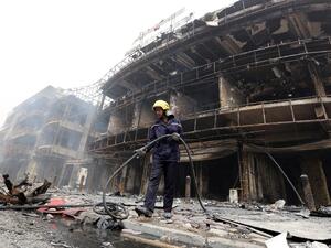 An Iraqi firefighter works at the site of a Baghdad bombing claimed by the Islamic State group on July 3. (AFP/Sabah Arar)