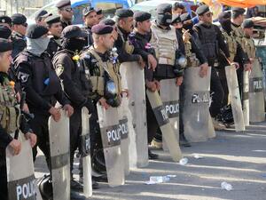 Iraqi security forces stand guard during a demonstration at Baghdad's Tahrir Square in May. (AFP/Jean Marc Mojon)