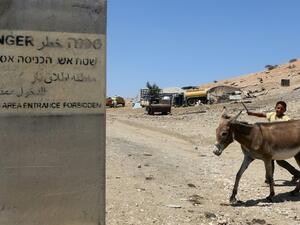 A sign on a concrete block reads "Firing area entrance forbidden" in Hebrew, Arabic and English (AFP/Jaafar Ashtiyeh)