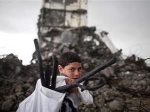 A Palestinian boy walks past a building destroyed in an Israeli airstrike in Beit Hanoun in the northern Gaza Strip, Jan. 24, 2016. (AFP/File) 