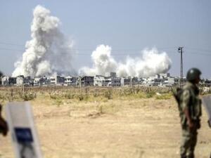 Smoke rises in the Syrian city of Kobani from heavy fighting seen from the Turkish border. (AFP/File)