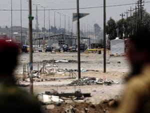 Kurdish Peshmerga forces look at a checkpoint held by Islamic State militants in Iraq's second city of Mosul. (AFP/Karim Sahib)