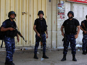 Palestinian security forces stand guard as riots take place in Nablus. (AFP/File) 
