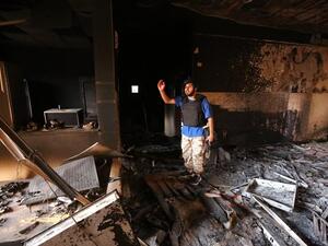 A fighter from the Government of National Unity (GNA) stands in a severely damaged state regulation prison after taking control of the area from the Daesh group in Sirte, east of the capital on August 26, 2016.